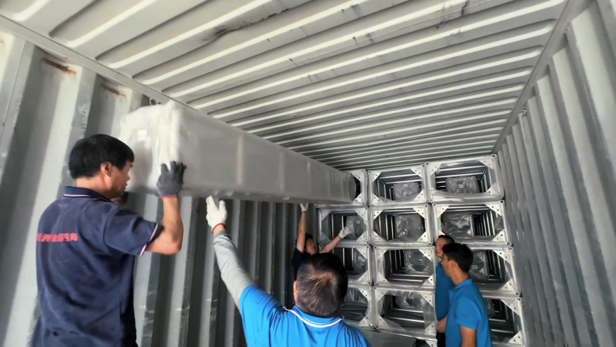 Workers loading aluminum stage truss products into export container warehouse site