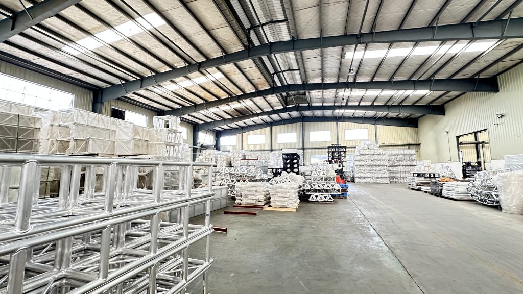 Finished aluminum truss systems stored in factory warehouse for stage construction projects
