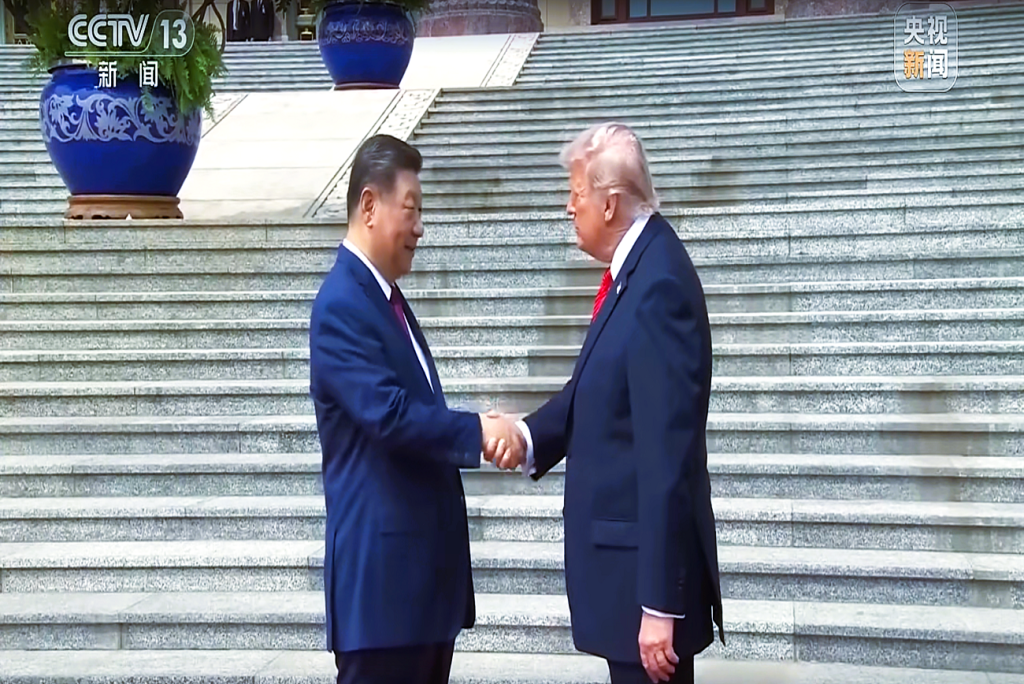 A handshake moment during an international meeting between Chinese and U.S. leaders