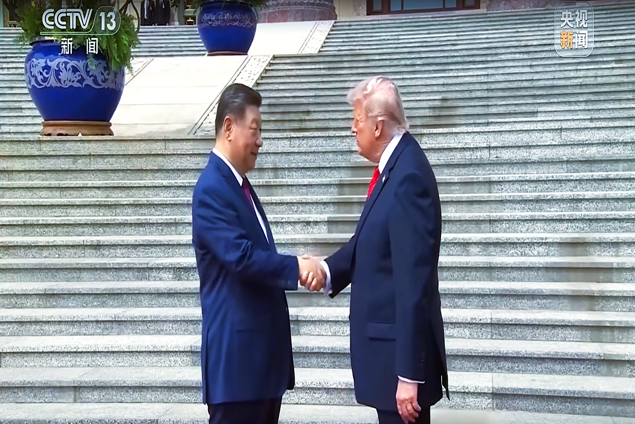 A handshake moment during an international meeting between Chinese and U.S. leaders
