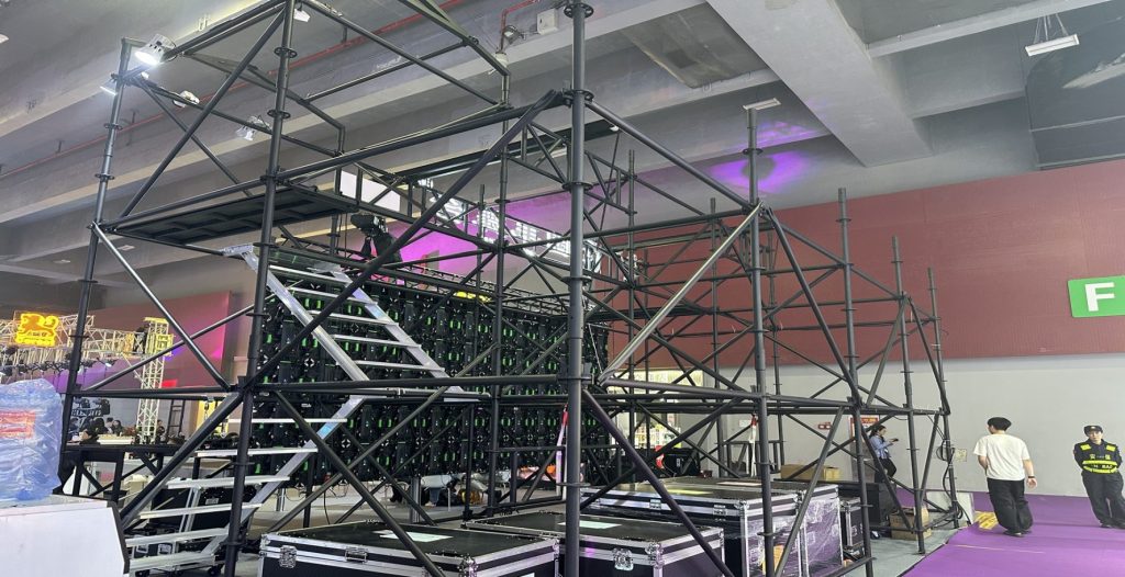 Two-level Ringlock scaffolding stage structure showing audience platform, lighting, and structural framework at VAC Music Festival