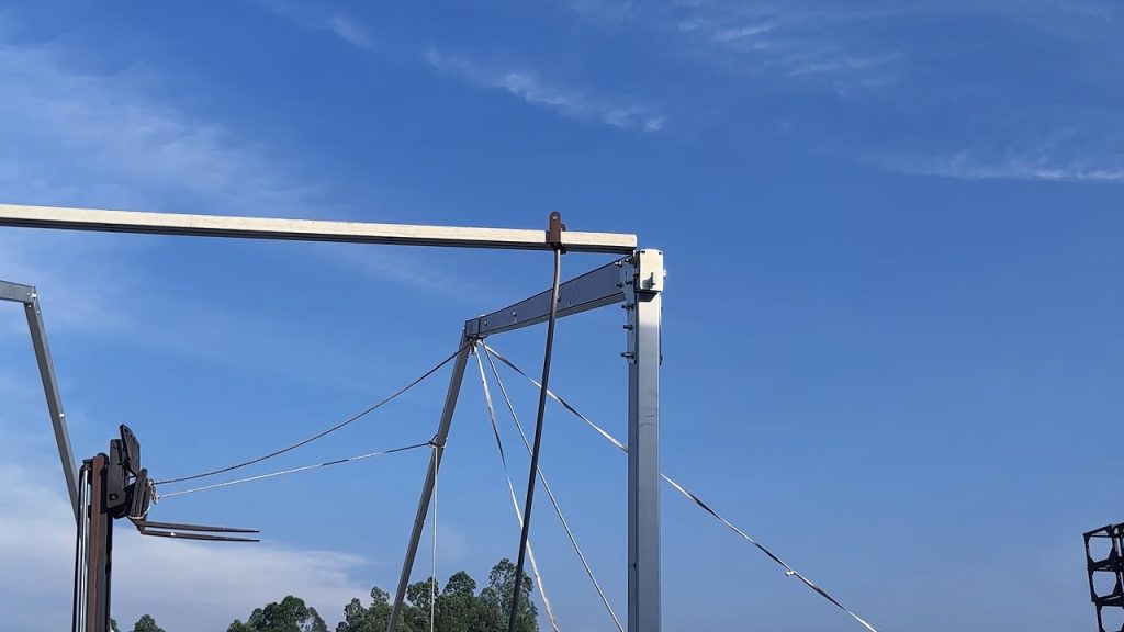 Control ropes adjusting the position of raised aluminum event tent frames