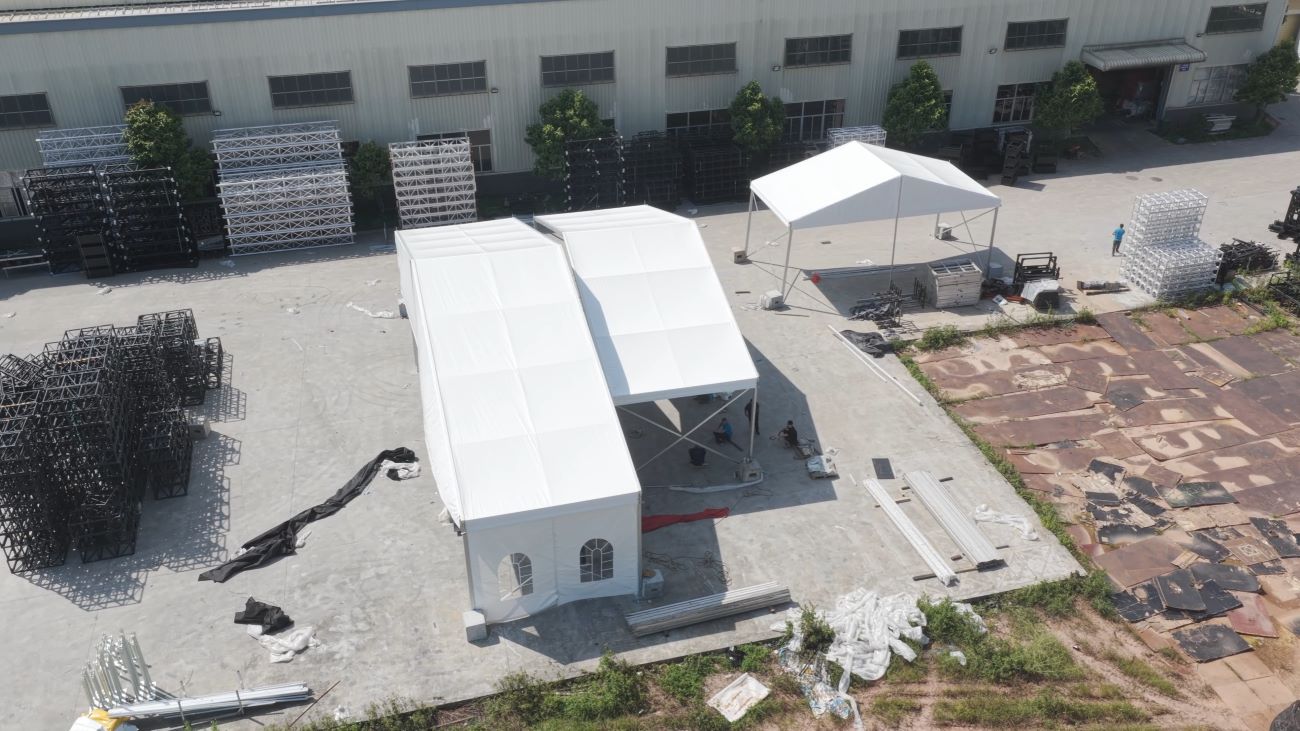 Completed outdoor event tent installation with aluminum frame and PVC cover